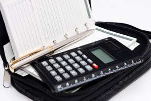 Calculator, pen and agenda in black organizer case